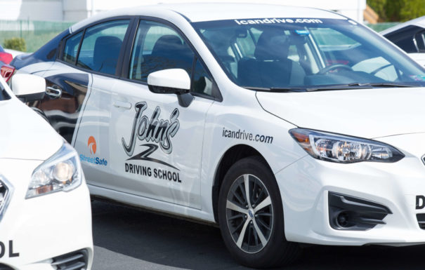 john's driving school white branded car